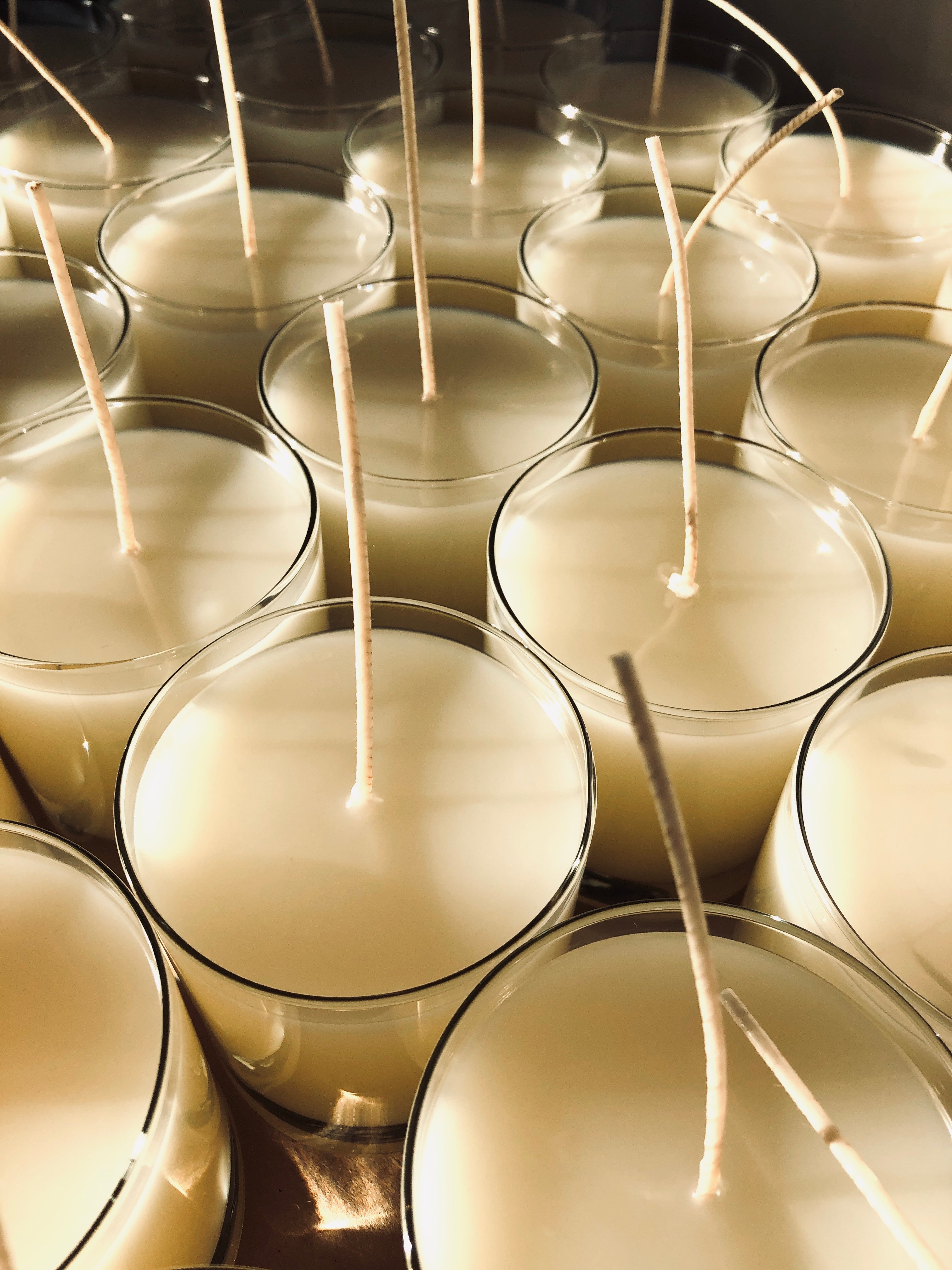 Candles tops with with long cotton wicks before trimming