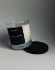 Picture of Cannabis and Lavendel Candle sitting on black lid against white backdrop.