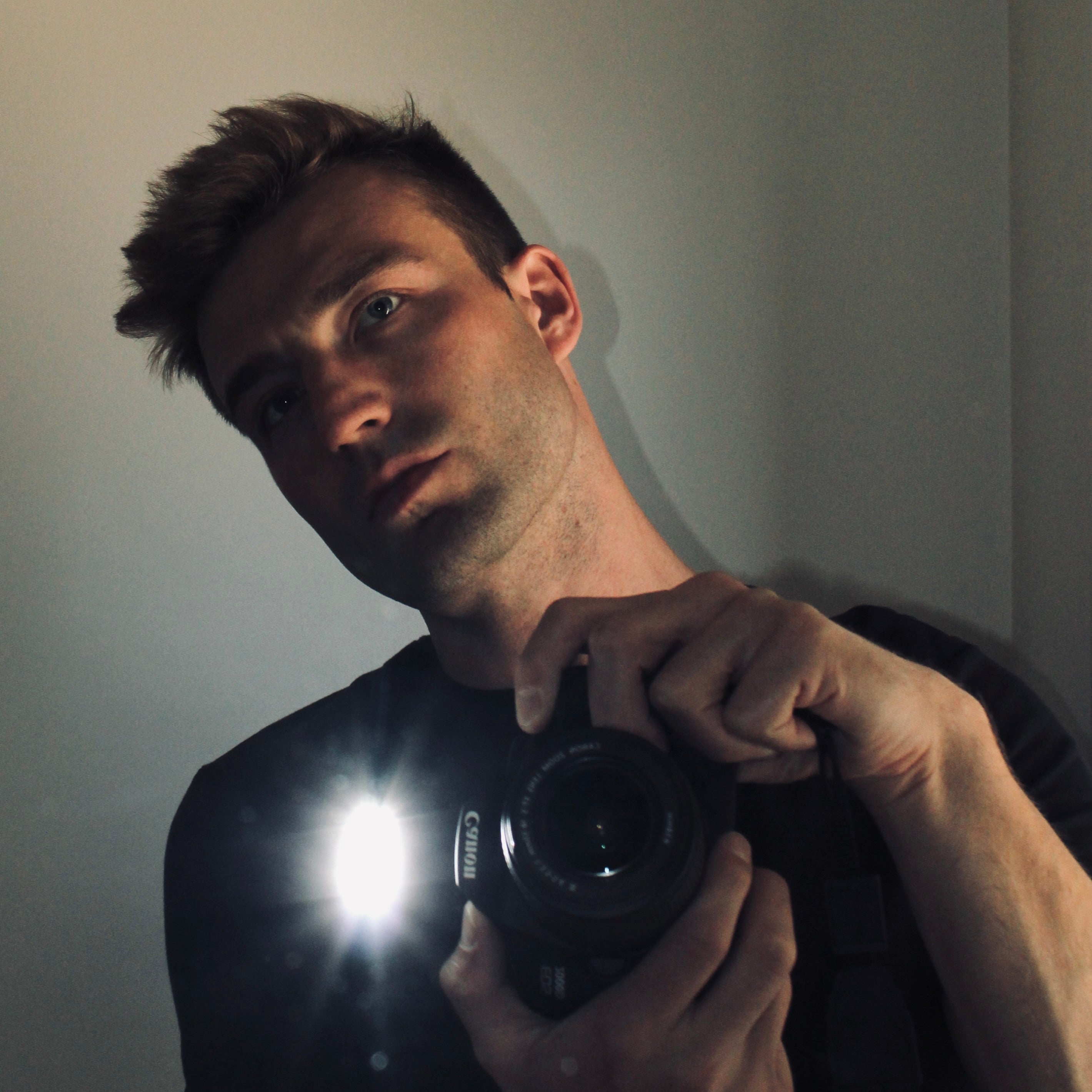 A selfie of LEHMANN DESIGN HAUS Founder Andrew Lehmann using cannon camera in mirror.