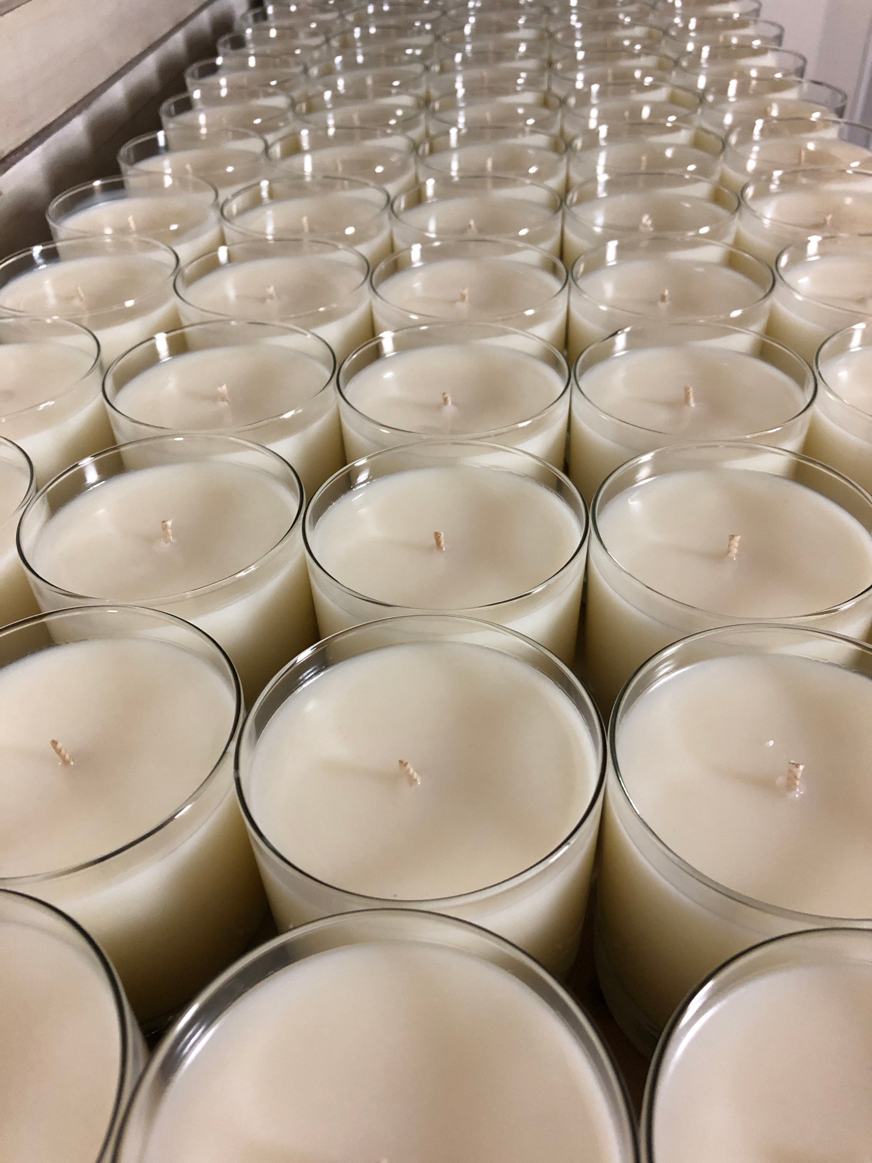 Table full of candles with trimmed cotton wicks